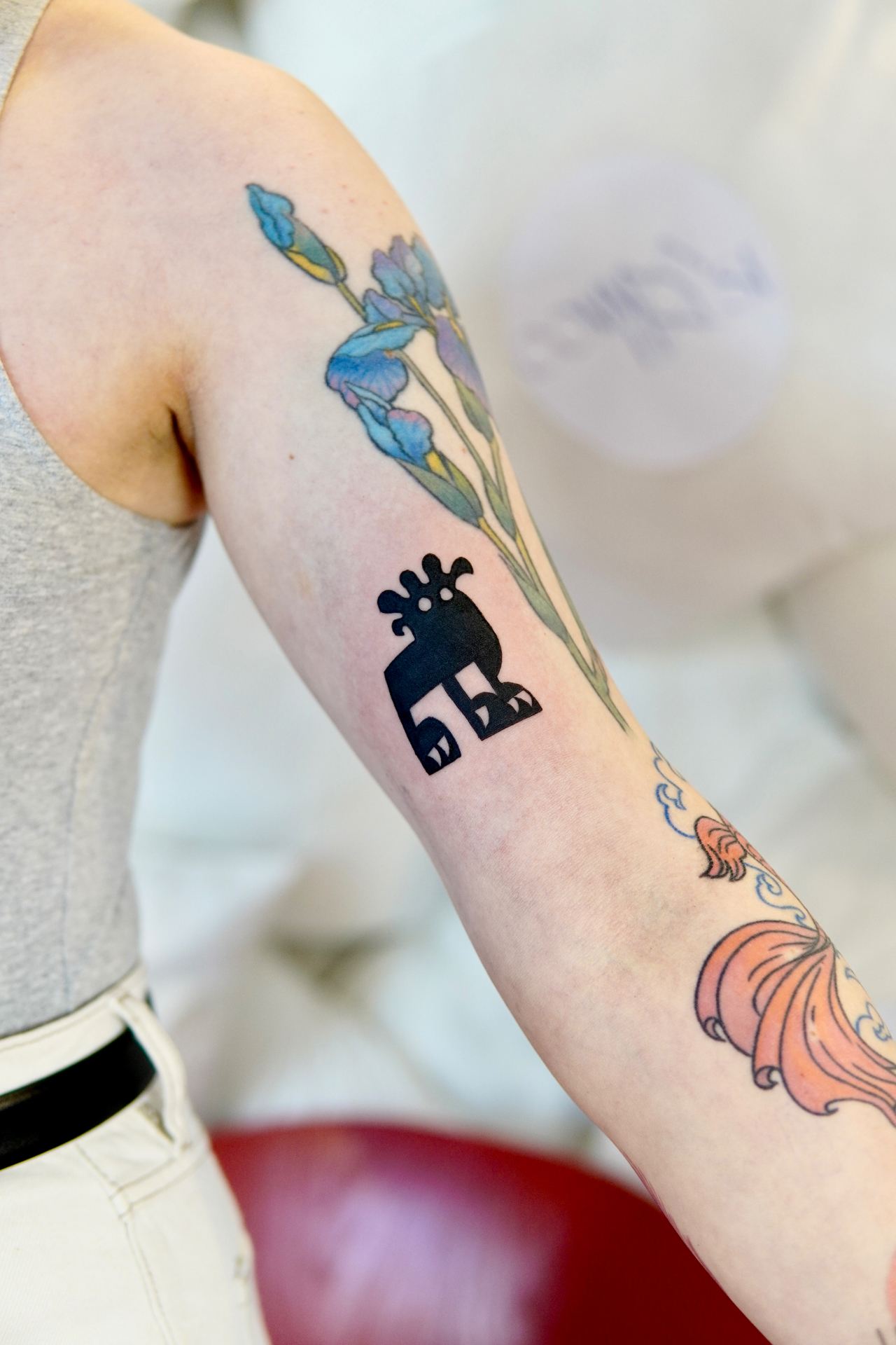 Black and grey folk creature tattoo