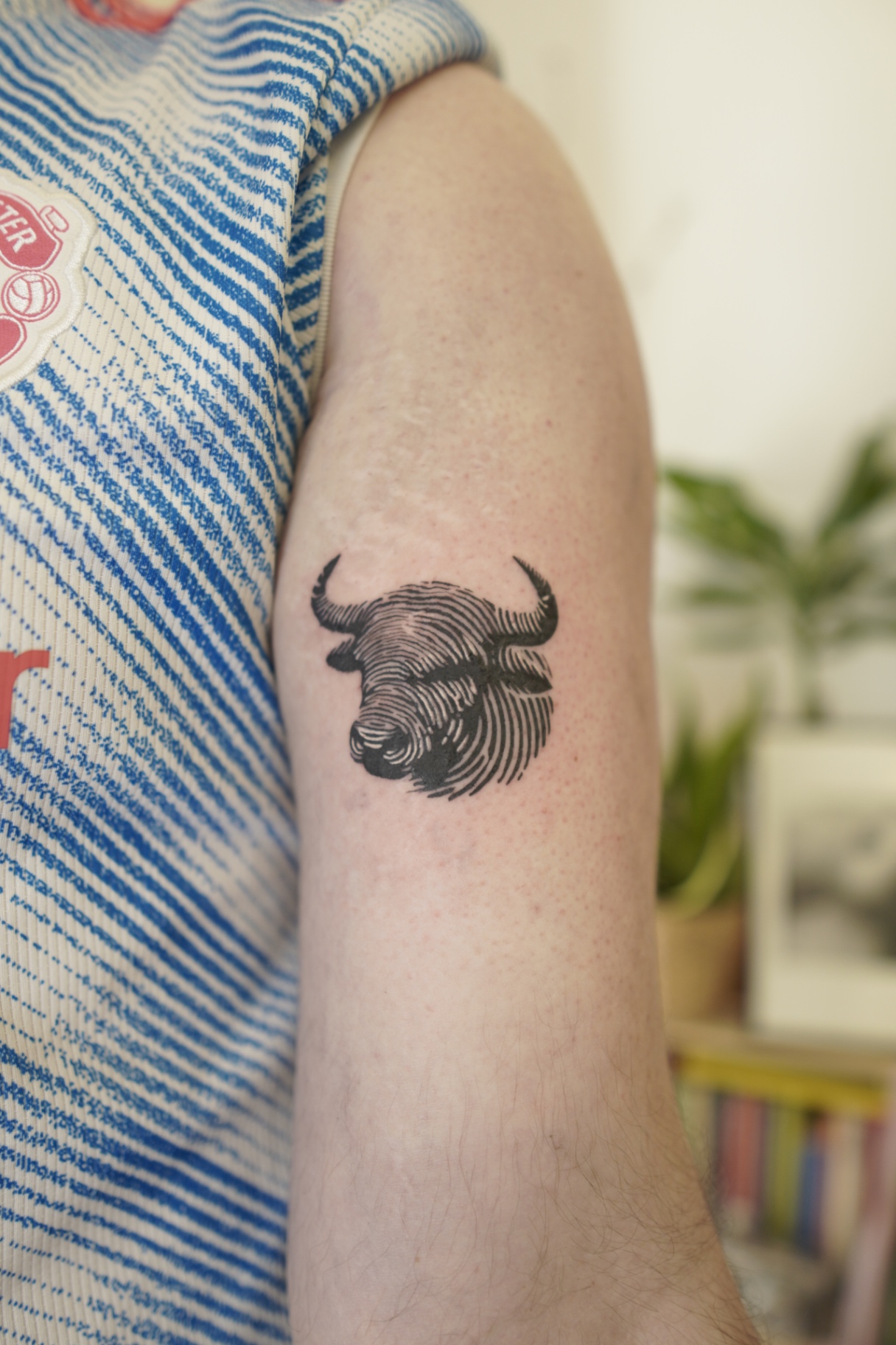 Detailed black and grey bull tattoo