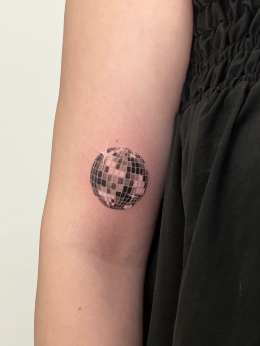 Micro realism disco ball tattoo on the arm