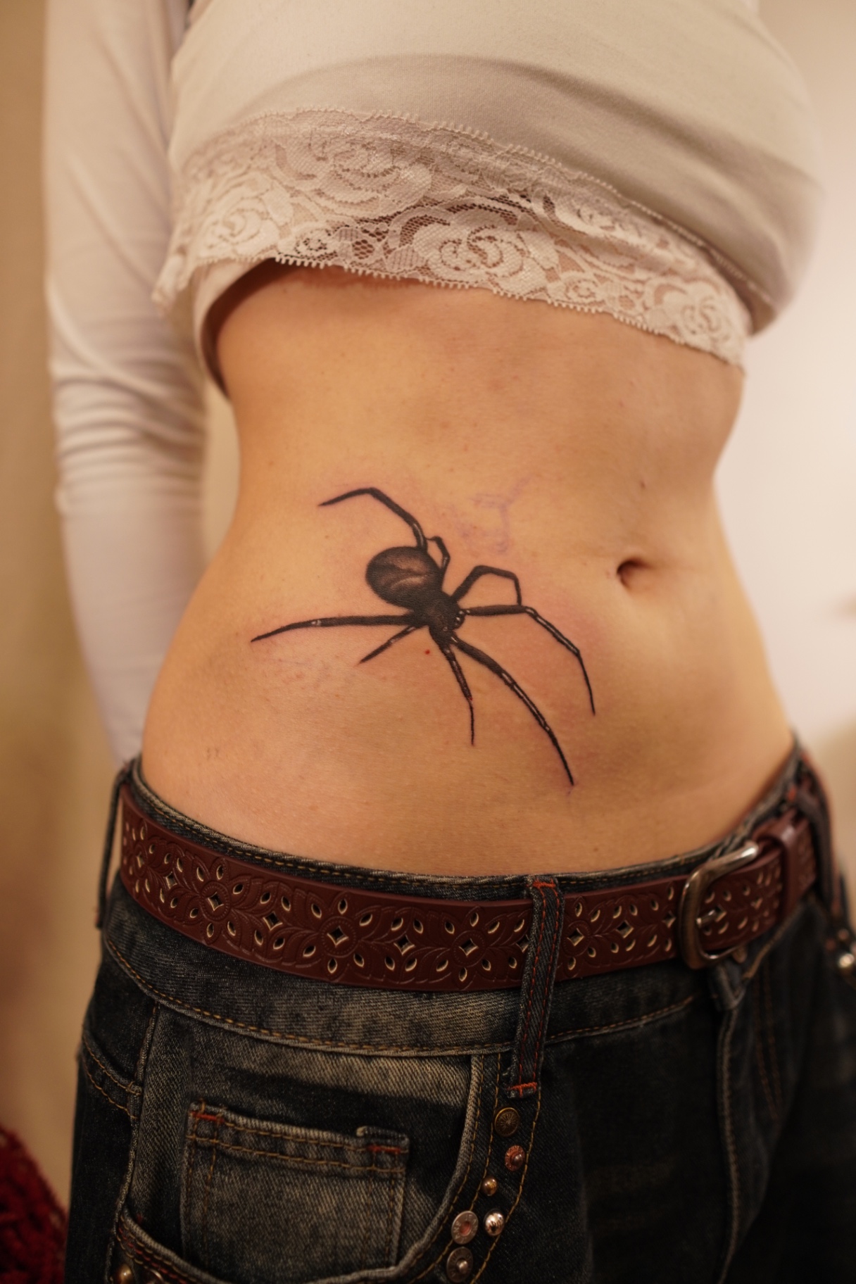 Black and grey spider tattoo