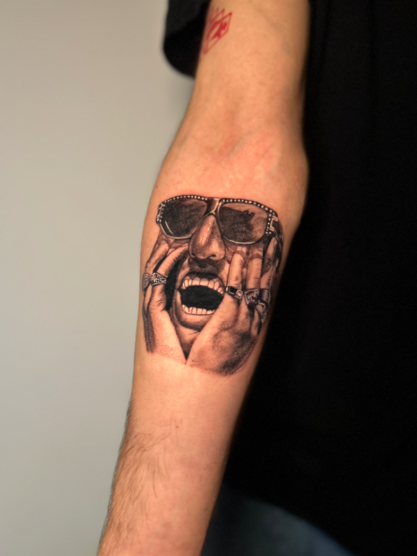 Black and grey realism portrait tattoo on the forearm